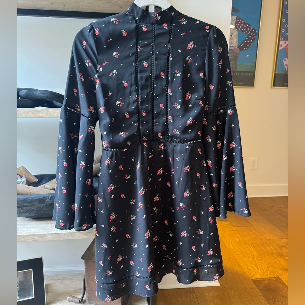 Black mini dress with floral print and bell sleeves